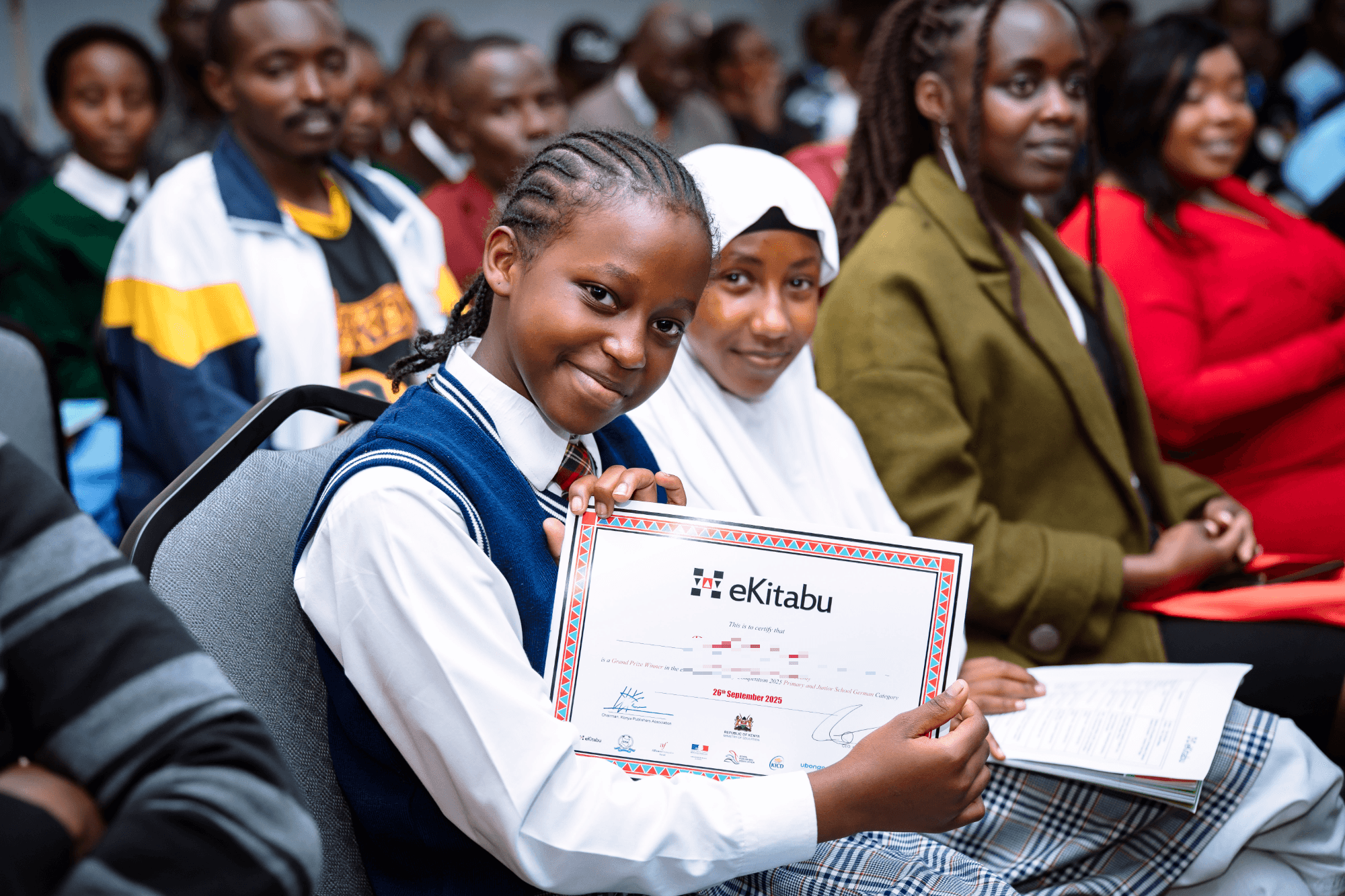 A Digital Essay Competition grand prize winner holding her eKitabu certificate